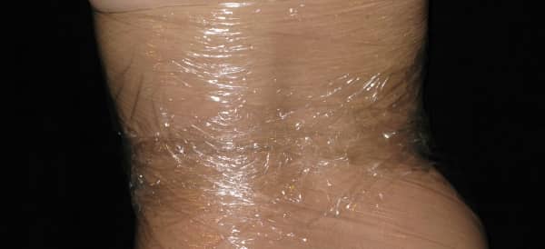 The woman is wearing a cling wrap costume