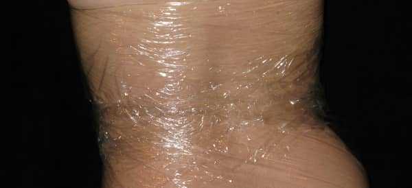 The woman is wearing a cling wrap costume The woman is wearing a cling wrap costume