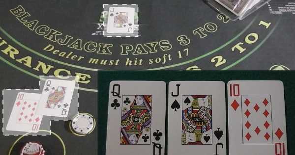 The initial cards are out and the dealer is determining the hand The initial cards are out and the dealer is determining the hand
