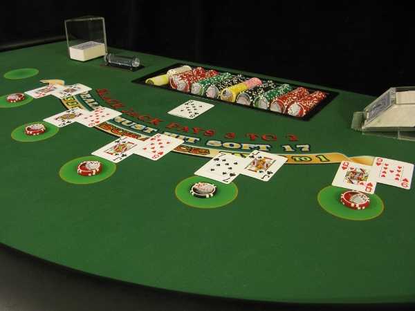 The blackjack table is full of people The blackjack table is full of people
