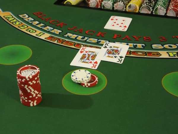 A blackjack bet that has two dollars heeled on top of it A blackjack bet that has two dollars heeled on top of it