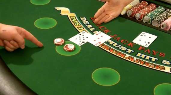 Player is using hand signals for doubling down Player is using hand signals for doubling down