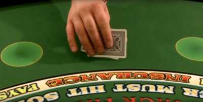 The player is blocking the view of their chips with their cards The player is blocking the view of their chips with their cards
