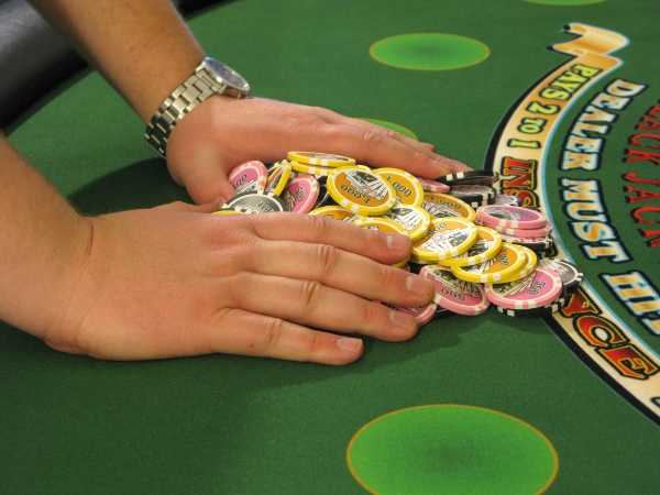 The player is pushing a pile of chips The player is pushing a pile of chips
