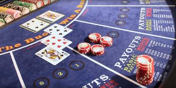 The dealer turns over the cards and spreads them so the cameras can see them