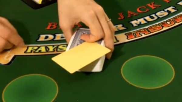 The dealer hands the cut card to the player on a single deck game The dealer hands the cut card to the player on a single deck game