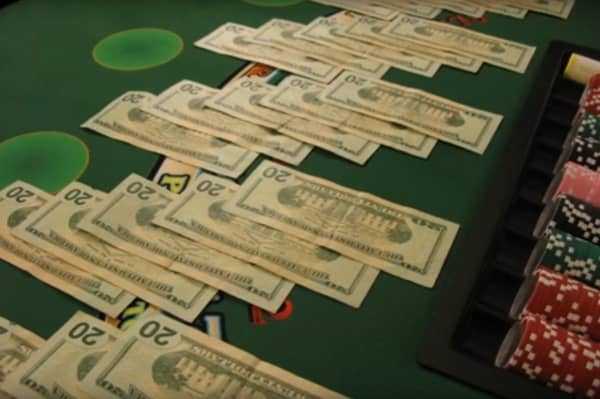 Cash spread out on a blackjack table Cash spread out on a blackjack table