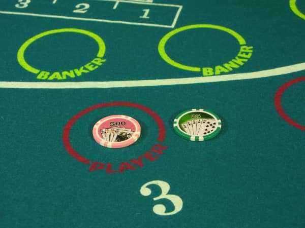 There is a five hundred dollar bet on Player along with a twenty five dollar toke next to it on a mini-baccarat table There is a five hundred dollar bet on Player along with a twenty five dollar toke next to it on a mini-baccarat table