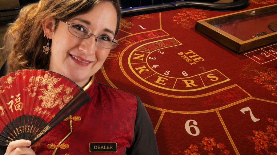 Heather in front of a Big Baccarat table holding a fan