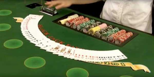 The dealer spreads the cards on the table The dealer spreads the cards on the table