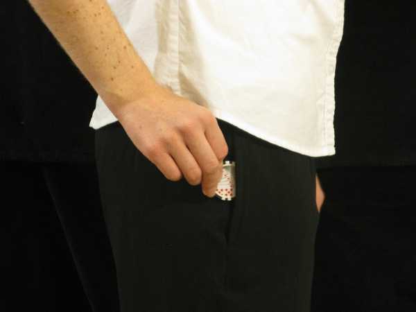 The dealer is putting a black chip in their pocket The dealer is putting a black chip in their pocket