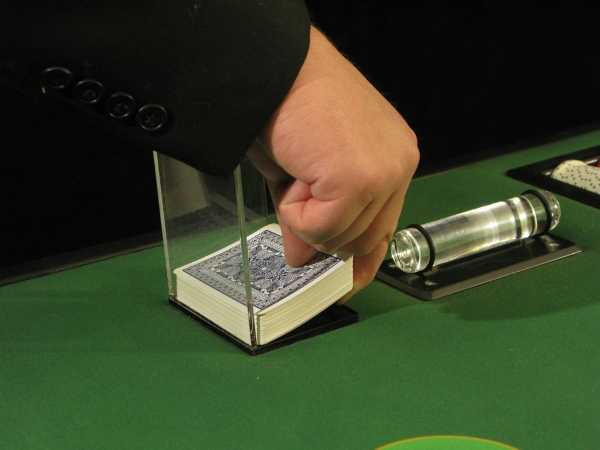 The floorman is picking up the discard deck The floorman is picking up the discard deck