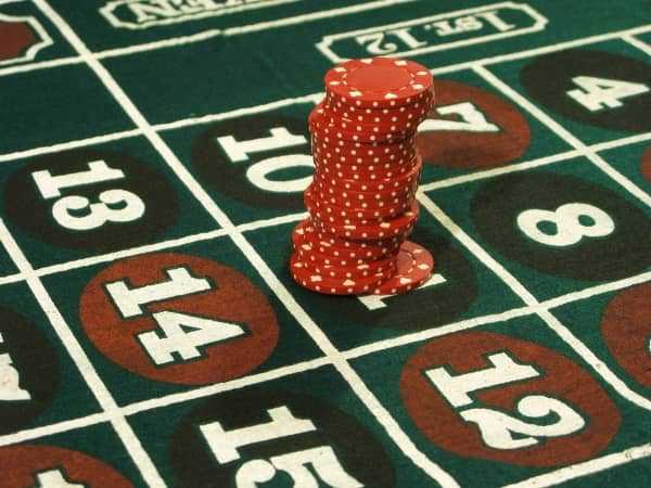 A large stack of chips is on one number on roulette A large stack of chips is on one number on roulette