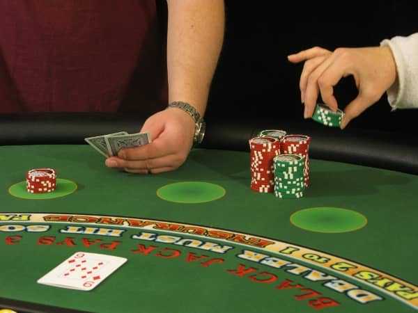 A woman is stealing chips from the player